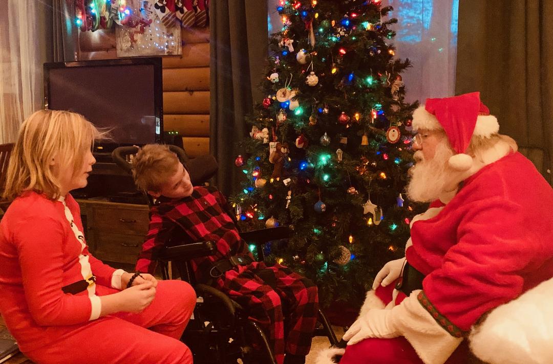 Kettle Moraine Santa paying a home visit to two young children.
